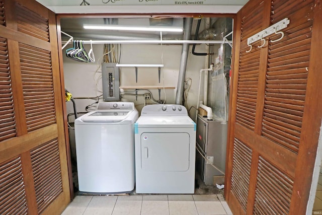 2907 Prairie Ln, Lafayette, IN 47904 - washroom featuring light tile patterned floors, electric panel, and washer and dryer