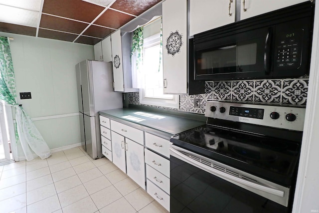 2907 Prairie Ln, Lafayette, IN 47904 - kitchen featuring appliances with stainless steel finishes, white cabinets, decorative backsplash, and light tile patterned flooring