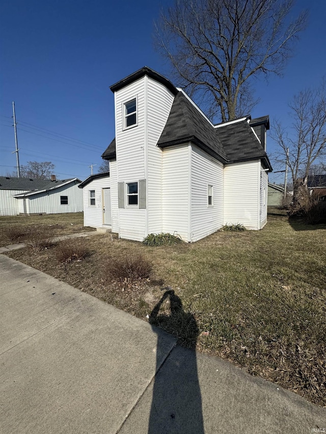 2806 S Walnut St, Muncie, IN 47302 - view of property exterior featuring a shingled roof and a lawn