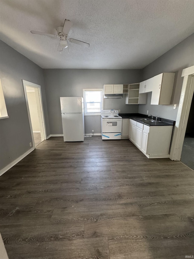 2806 S Walnut St, Muncie, IN 47302 - kitchen featuring white appliances, dark countertops, dark wood-style flooring, a textured ceiling, and ceiling fan