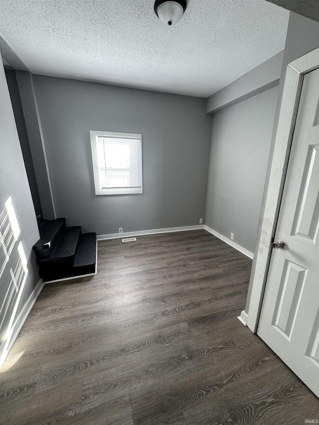 2806 S Walnut St, Muncie, IN 47302 - unfurnished bedroom featuring wood finished floors and a textured ceiling