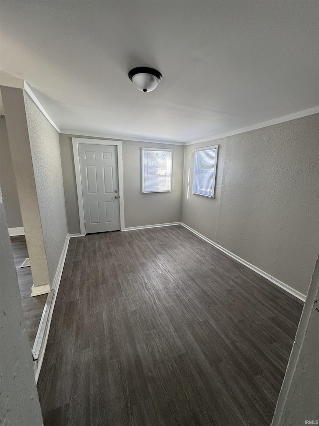 2806 S Walnut St, Muncie, IN 47302 - foyer with dark wood finished floors, a textured wall, and ornamental molding