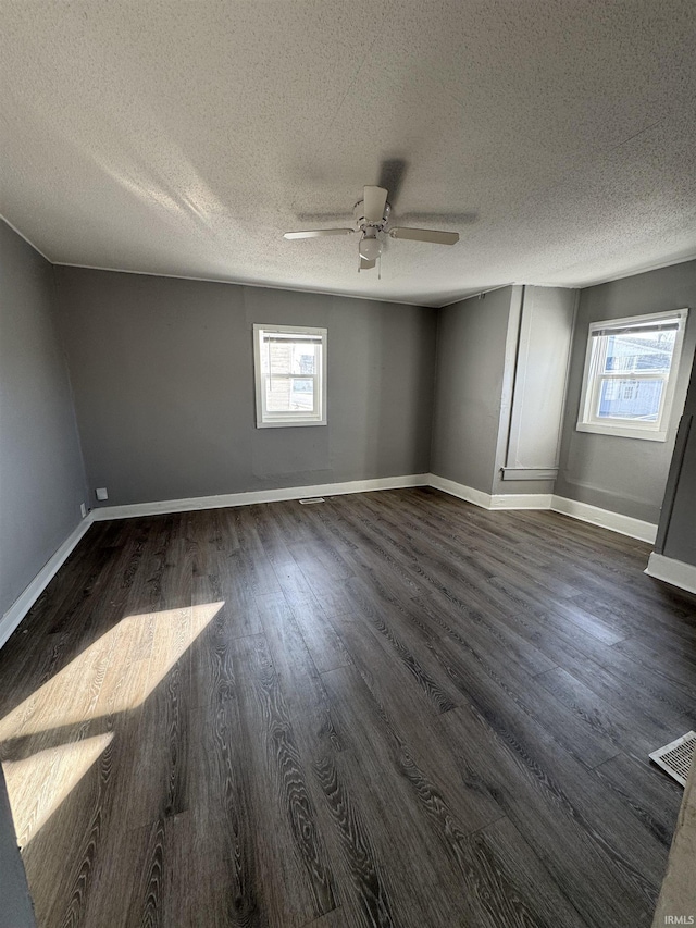 2806 S Walnut St, Muncie, IN 47302 - unfurnished room with a ceiling fan, healthy amount of natural light, dark wood-style floors, and a textured ceiling