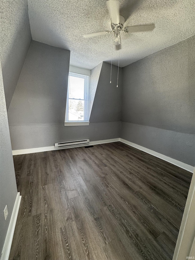 2806 S Walnut St, Muncie, IN 47302 - bonus room with dark wood-style floors, baseboard heating, a ceiling fan, a textured ceiling, and lofted ceiling