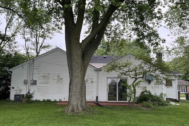 615 Springbrook Rd, Fort Wayne, IN 46825 - back of property featuring a lawn and a chimney