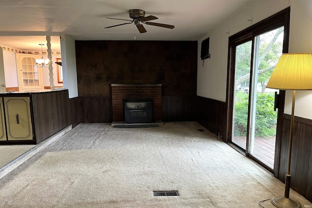 615 Springbrook Rd, Fort Wayne, IN 46825 - unfurnished living room with light colored carpet, healthy amount of natural light, a ceiling fan, wainscoting, and wood walls