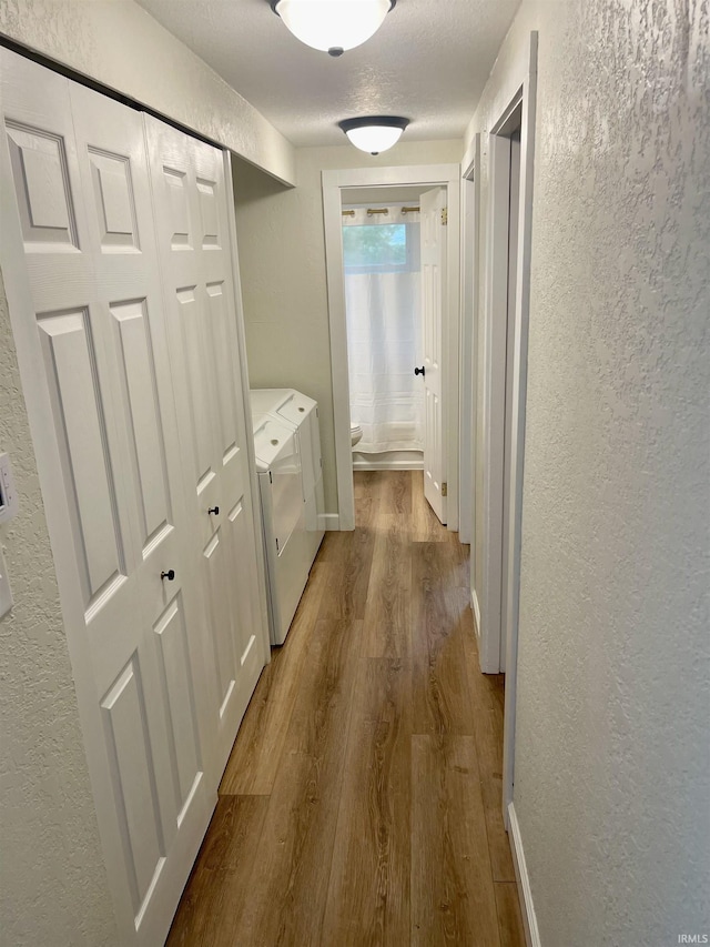 210 Gladstone Dr, Wabash, IN 46992 - hallway featuring a textured wall, washer and clothes dryer, and dark wood-type flooring