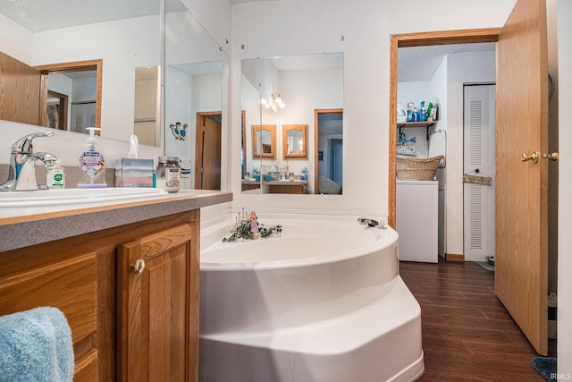 205 Par Blvd, Bristol, IN 46507 - bathroom featuring wood finished floors, a bath, vanity, a closet, and washer / dryer