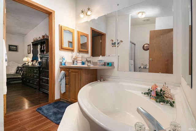 205 Par Blvd, Bristol, IN 46507 - bathroom with wood finished floors, vanity, and a bath