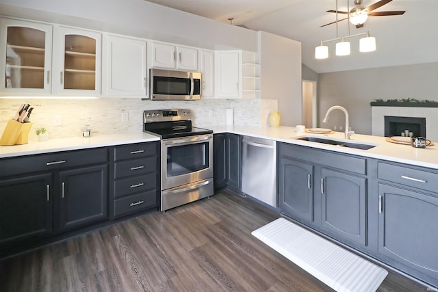 3847 Lodi Ln, Lafayette, IN 47905 - kitchen featuring stainless steel appliances, ceiling fan, white cabinetry, decorative backsplash, and glass insert cabinets