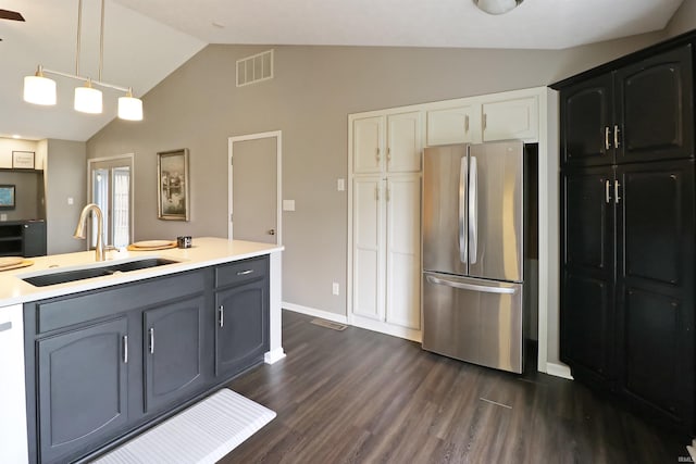 3847 Lodi Ln, Lafayette, IN 47905 - kitchen featuring freestanding refrigerator, vaulted ceiling, light countertops, dark wood-style floors, and hanging light fixtures