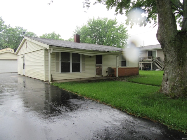 2305 Hillis Ct, Kokomo, IN 46902 - ranch-style house with a chimney, a front lawn, and an outdoor structure