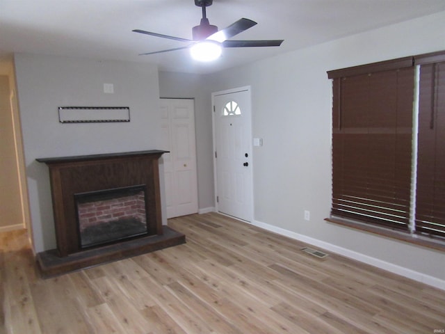 2305 Hillis Ct, Kokomo, IN 46902 - unfurnished living room with a ceiling fan, light wood-style flooring, and a fireplace with raised hearth