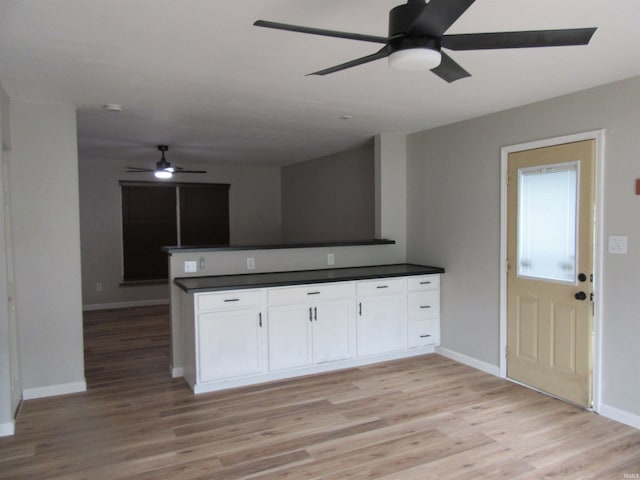 2305 Hillis Ct, Kokomo, IN 46902 - kitchen featuring ceiling fan, dark countertops, white cabinets, light wood finished floors, and open floor plan