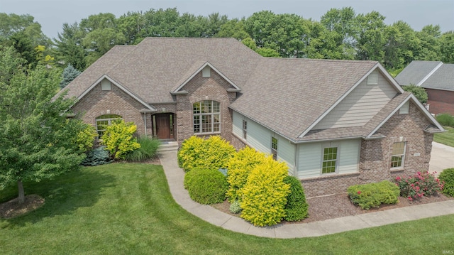 3507 Wakefield Dr, West Lafayette, IN 47906 - view of front facade featuring brick siding, a front lawn, and a shingled roof