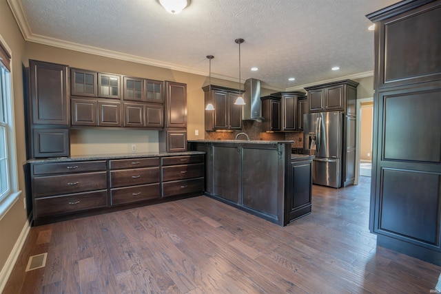 3507 Wakefield Dr, West Lafayette, IN 47906 - kitchen with stainless steel fridge with ice dispenser, dark brown cabinets, wall chimney range hood, a textured ceiling, and ornamental molding