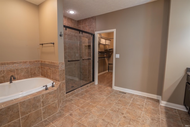 3507 Wakefield Dr, West Lafayette, IN 47906 - bathroom with a bath, a shower stall, a spacious closet, vanity, and a textured ceiling