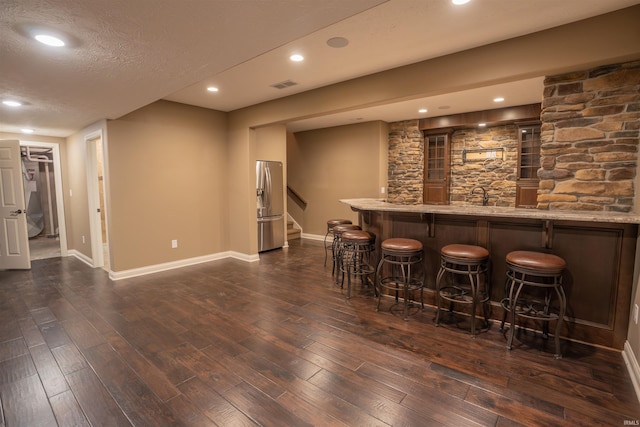 3507 Wakefield Dr, West Lafayette, IN 47906 - indoor wet bar with stainless steel refrigerator with ice dispenser, dark wood finished floors, stairs, recessed lighting, and a textured ceiling