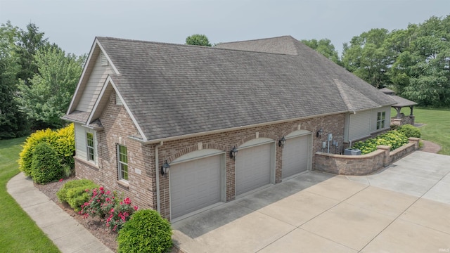 3507 Wakefield Dr, West Lafayette, IN 47906 - view of home's exterior with an attached garage, concrete driveway, brick siding, and a shingled roof