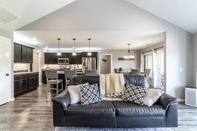1492 Monte Carlo Dr, Huntertown, IN 46748 - living area with vaulted ceiling, dark wood-style floors, a chandelier, and recessed lighting
