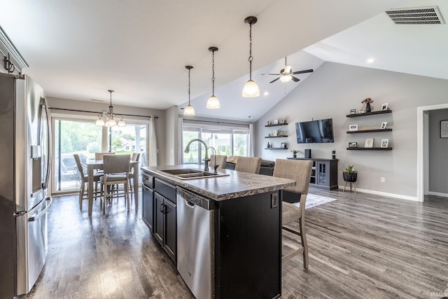 1492 Monte Carlo Dr, Huntertown, IN 46748 - kitchen featuring stainless steel appliances, ceiling fan, a breakfast bar area, wood finished floors, and high vaulted ceiling