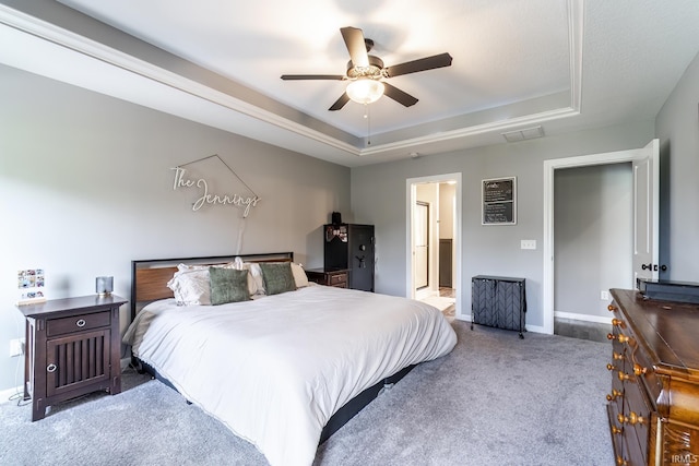 1492 Monte Carlo Dr, Huntertown, IN 46748 - carpeted bedroom with a tray ceiling, ceiling fan, and ensuite bathroom