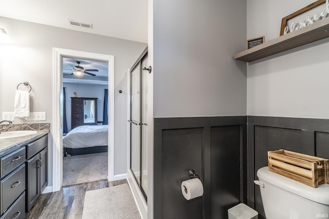 1492 Monte Carlo Dr, Huntertown, IN 46748 - bathroom featuring wood finished floors, ensuite bathroom, ceiling fan, a shower stall, and vanity