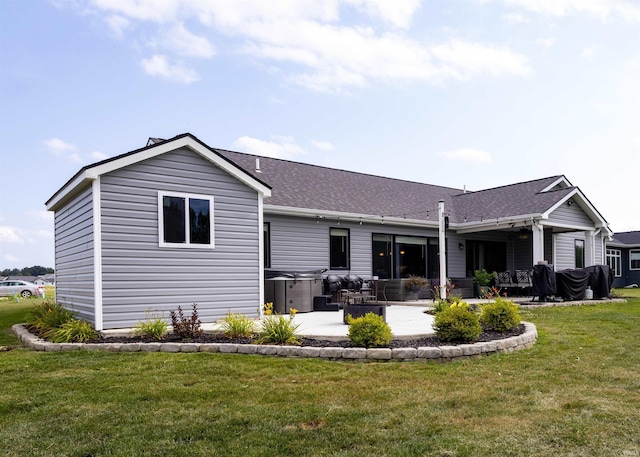 1492 Monte Carlo Dr, Huntertown, IN 46748 - back of property featuring a patio, a lawn, and a shingled roof