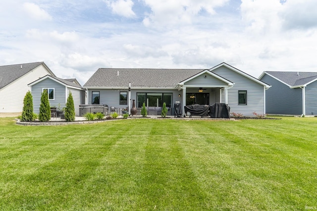 1492 Monte Carlo Dr, Huntertown, IN 46748 - rear view of house featuring a hot tub, a ceiling fan, a patio, and a lawn