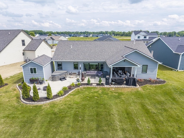 1492 Monte Carlo Dr, Huntertown, IN 46748 - back of house featuring a hot tub, a patio area, a shingled roof, outdoor lounge area, and a yard