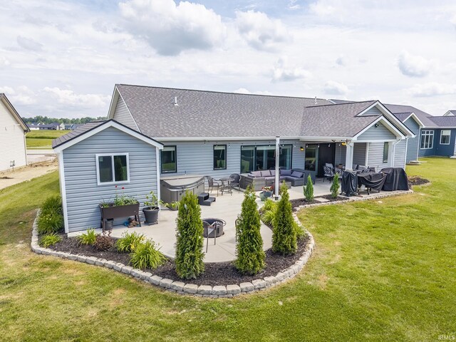 1492 Monte Carlo Dr, Huntertown, IN 46748 - back of house featuring a hot tub, an outdoor living space, a patio area, and a shingled roof