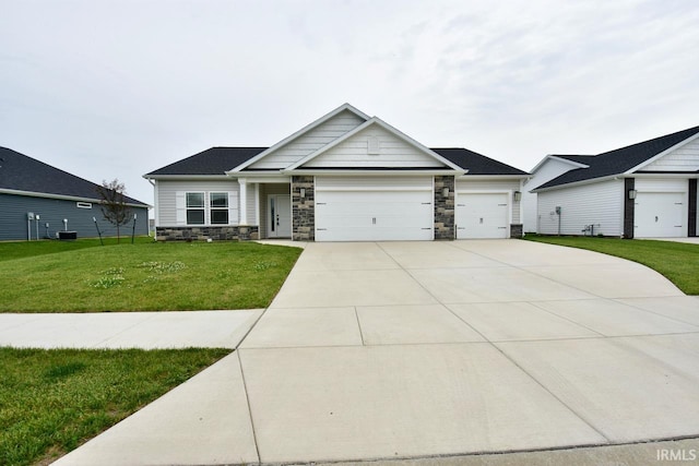 146 Hayloft Dr, West Lafayette, IN 47906 - craftsman-style house with stone siding, an attached garage, a front lawn, and concrete driveway