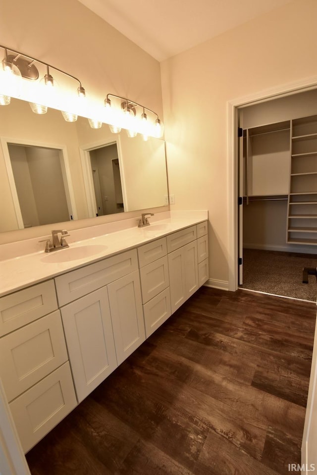 146 Hayloft Dr, West Lafayette, IN 47906 - bathroom featuring double vanity, wood finished floors, and a spacious closet