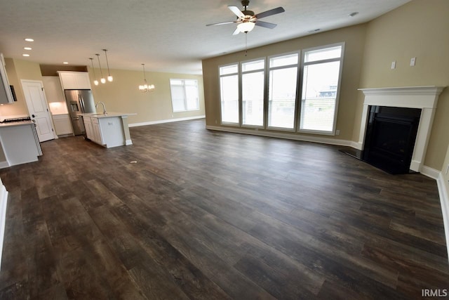 146 Hayloft Dr, West Lafayette, IN 47906 - unfurnished living room featuring a ceiling fan, a fireplace, dark wood-type flooring, a chandelier, and recessed lighting