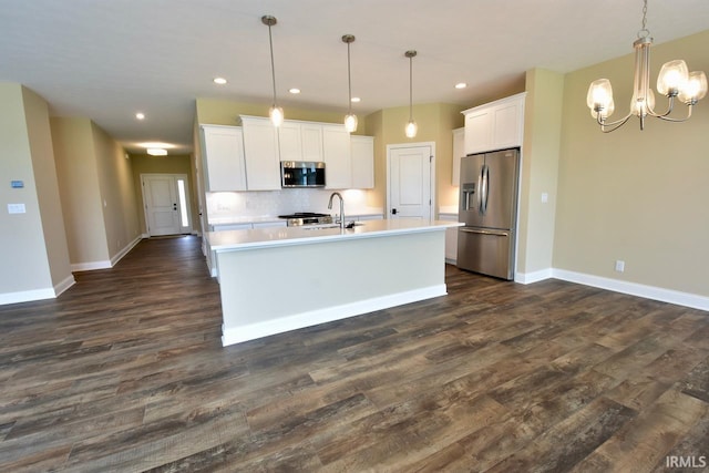 146 Hayloft Dr, West Lafayette, IN 47906 - kitchen featuring stainless steel appliances, light countertops, a chandelier, white cabinets, and dark wood-type flooring