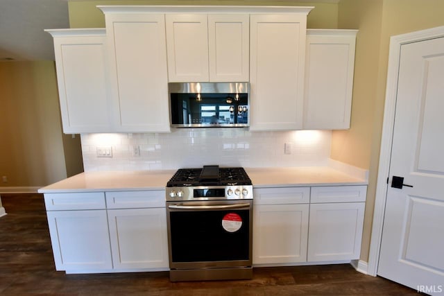 146 Hayloft Dr, West Lafayette, IN 47906 - kitchen featuring appliances with stainless steel finishes, white cabinets, tasteful backsplash, light countertops, and dark wood-style flooring
