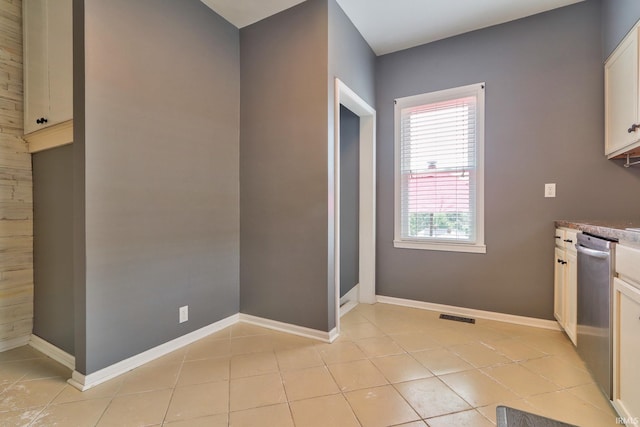 2736 Marion Ave, Evansville, IN 47712 - kitchen with stainless steel dishwasher, light tile patterned floors, and white cabinets