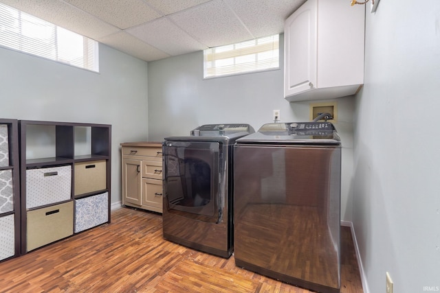 2736 Marion Ave, Evansville, IN 47712 - laundry room with cabinet space, independent washer and dryer, plenty of natural light, and wood finished floors