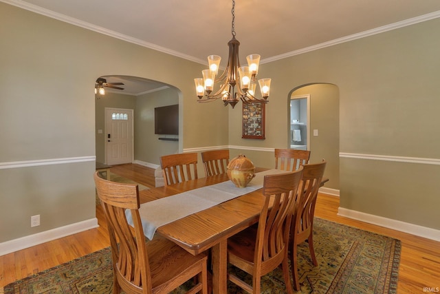 2736 Marion Ave, Evansville, IN 47712 - dining room with arched walkways, wood finished floors, a chandelier, crown molding, and ceiling fan