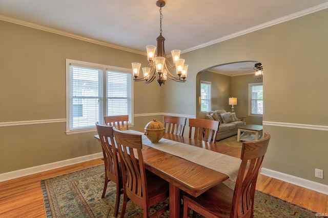 2736 Marion Ave, Evansville, IN 47712 - dining space with arched walkways, a chandelier, ornamental molding, light wood finished floors, and ceiling fan