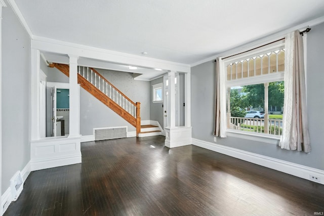 1015 Columbia Ave, Fort Wayne, IN 46805 - unfurnished living room featuring ornate columns, wood finished floors, healthy amount of natural light, stairs, and crown molding