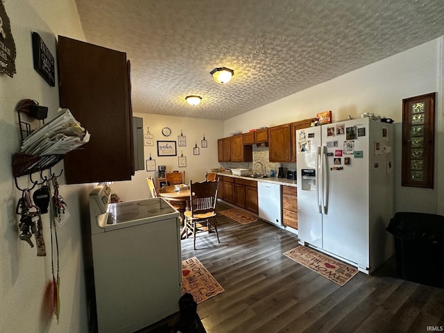 13687 E Ivan Ct, Bloomington, IN 47403 - kitchen with white appliances, dark wood-type flooring, a textured ceiling, light countertops, and brown cabinets