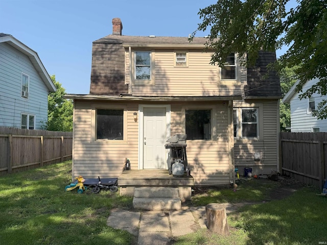 1814 S Douglas St, South Bend, IN 46613 - back of house featuring a chimney, a fenced backyard, and roof with shingles