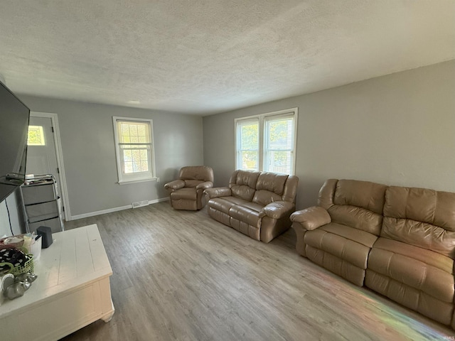 1814 S Douglas St, South Bend, IN 46613 - living room with wood finished floors, plenty of natural light, and a textured ceiling