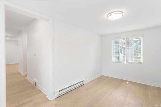 1415 S Main St, Goshen, IN 46526 - empty room with a baseboard radiator and light wood-style flooring