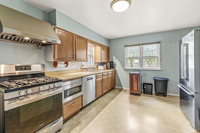 422 W Lawrence St, Mishawaka, IN 46545 - kitchen with appliances with stainless steel finishes, wall chimney exhaust hood, healthy amount of natural light, and light countertops