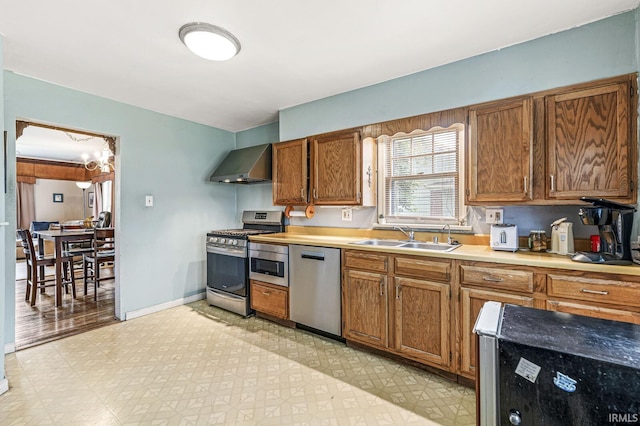 422 W Lawrence St, Mishawaka, IN 46545 - kitchen with stainless steel appliances, wall chimney range hood, light flooring, and light countertops