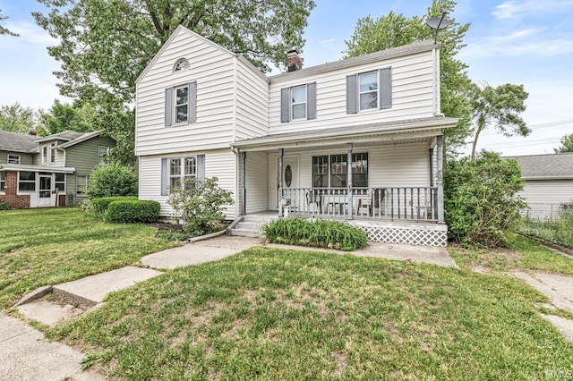422 W Lawrence St, Mishawaka, IN 46545 - view of front of home featuring a porch, a front lawn, and a chimney