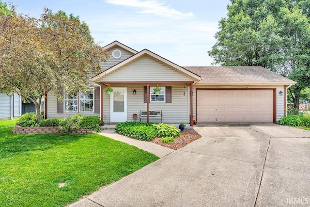 3317 Jacob Pl, Lafayette, IN 47909 - view of front of house with an attached garage, a front lawn, driveway, and covered porch