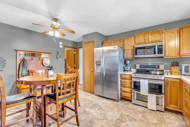 3317 Jacob Pl, Lafayette, IN 47909 - kitchen featuring appliances with stainless steel finishes, light countertops, ceiling fan, and a textured ceiling
